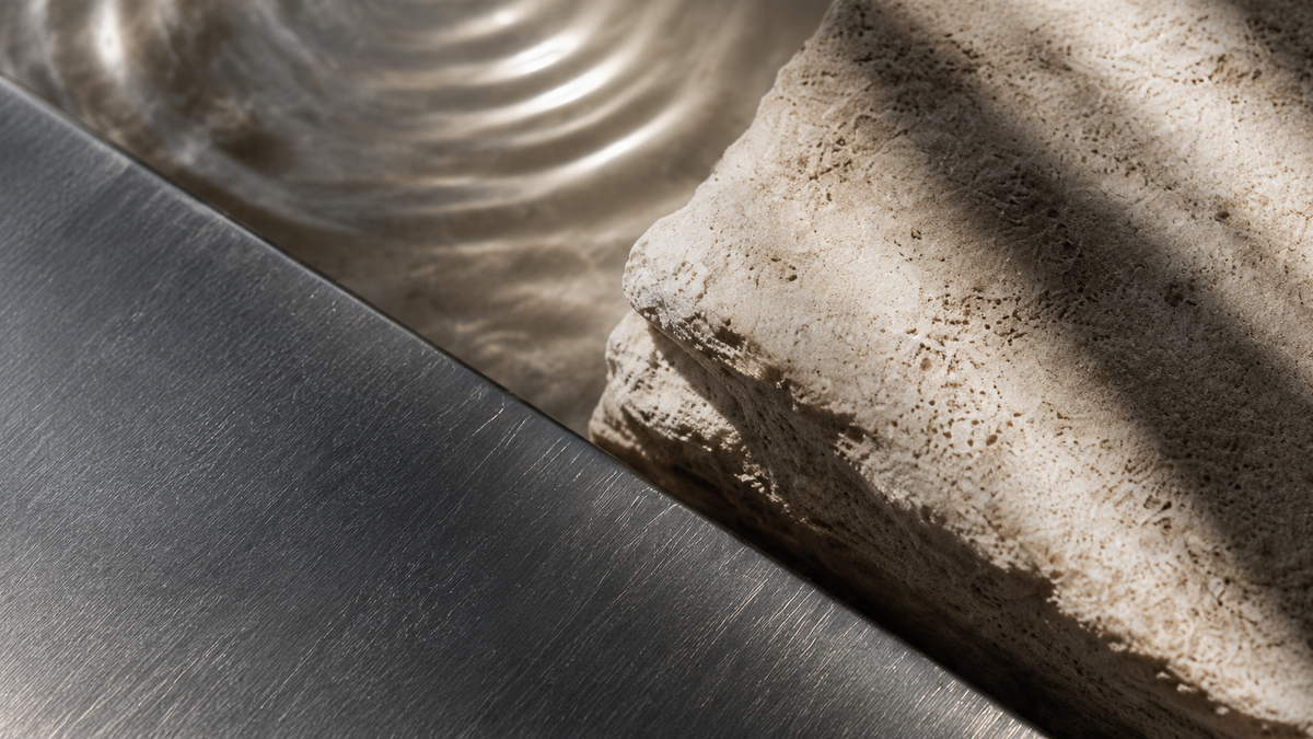 Stone, water and brushed metal in warm natural shadow